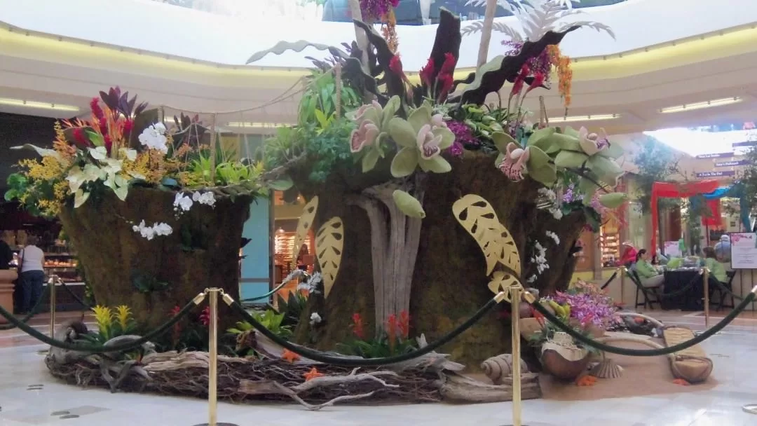 Exotic flower arrangement display in a mall with tropical theme decoration