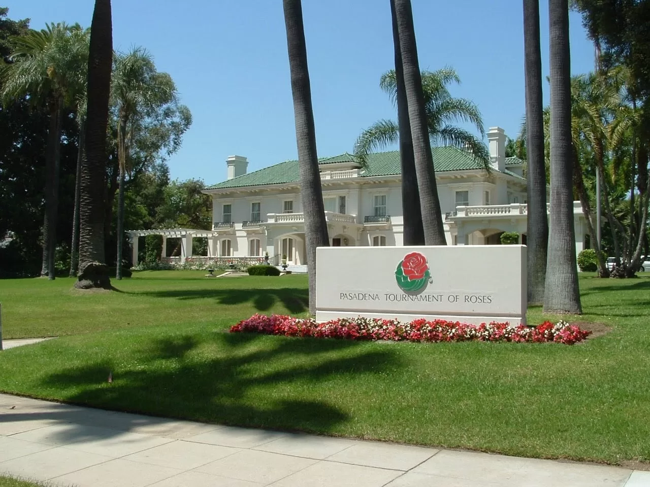 Luxurious mansion with palm trees and Tournament of Roses sign in Pasadena