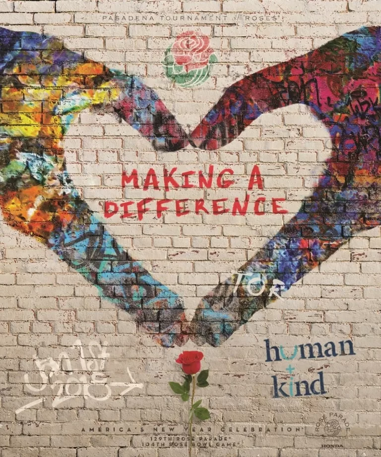 Colorful heart-shaped mural on brick wall with text "Making A Difference" and a single rose.